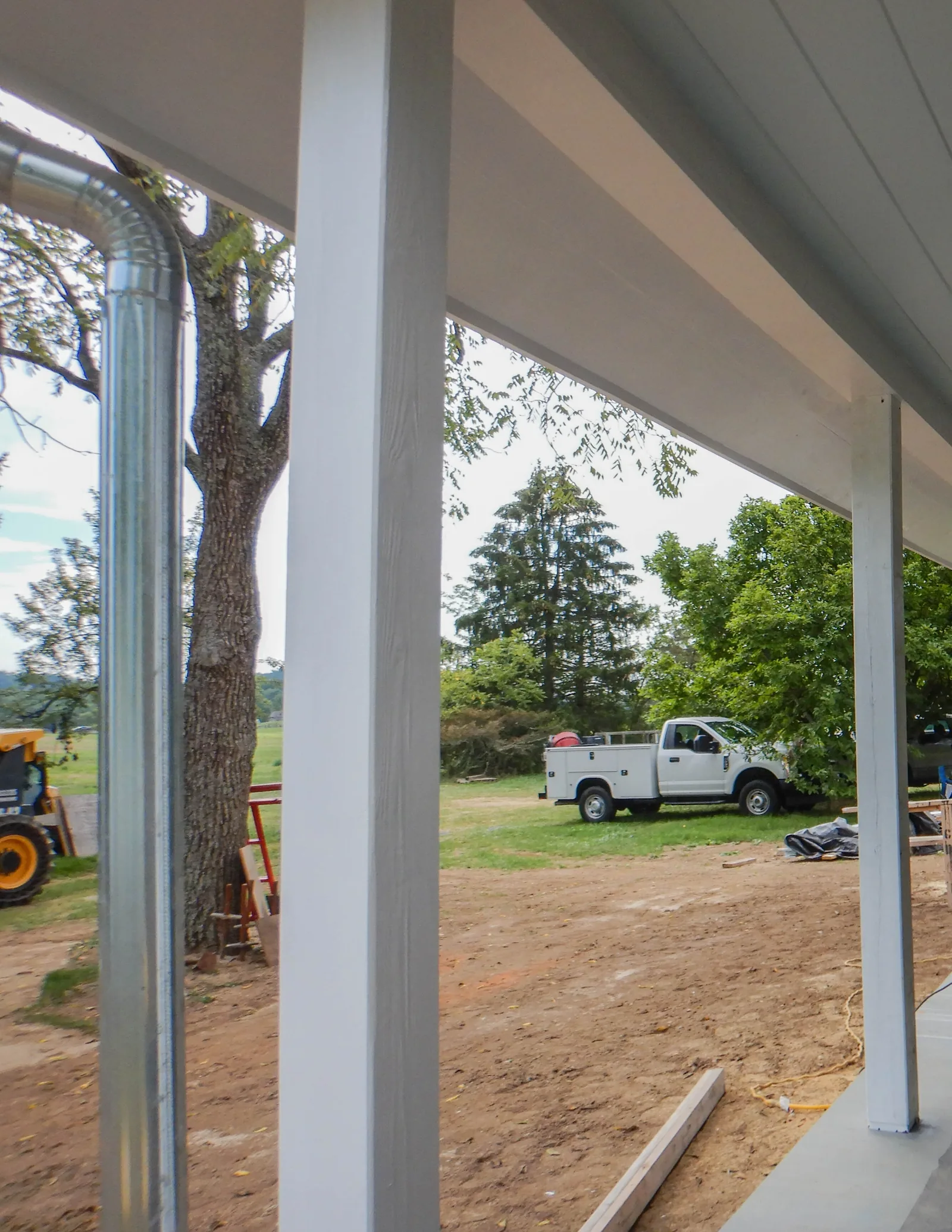 New primed porch support posts and ceiling during construction